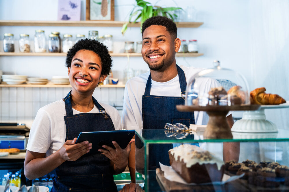 Barista and waiter working in a busy UK café – Small business for sale by owner guide