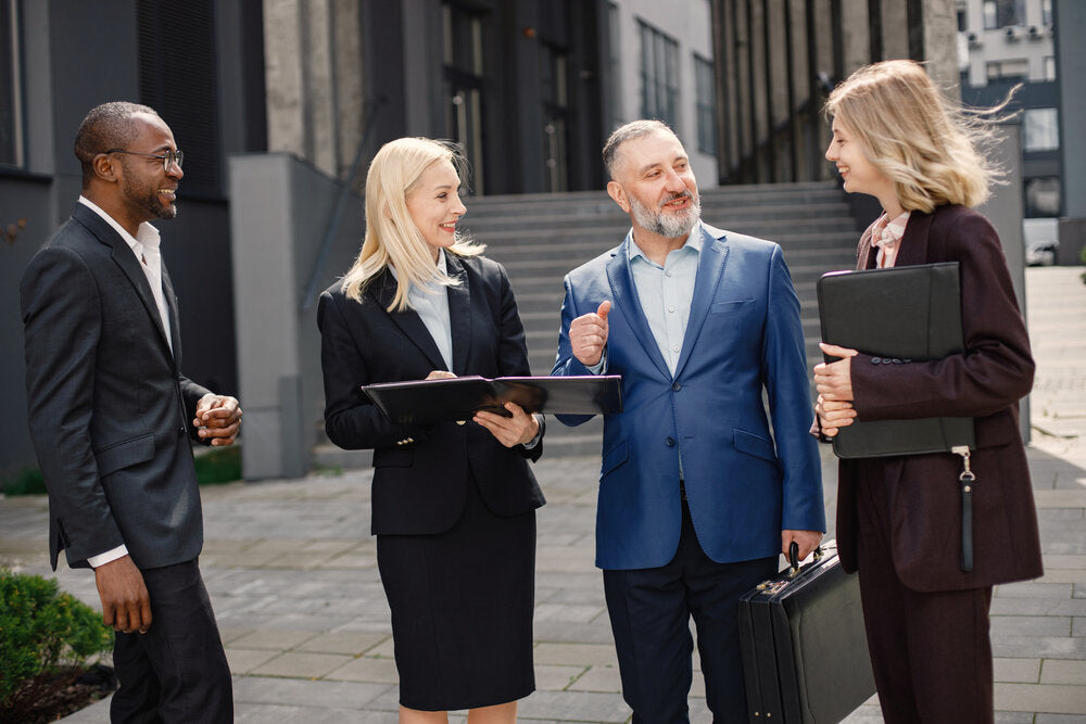 Business professionals discussing opportunities with top UK business brokers to buy or sell a business.