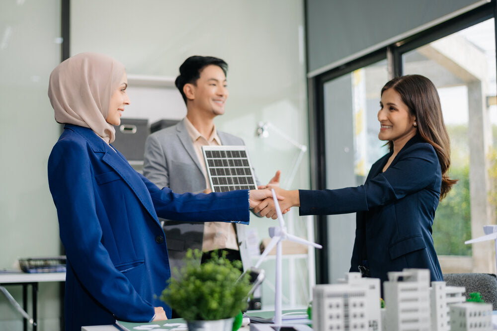 Business professionals discussing wind energy project strategy during a consultation – Sell a Business concept.
