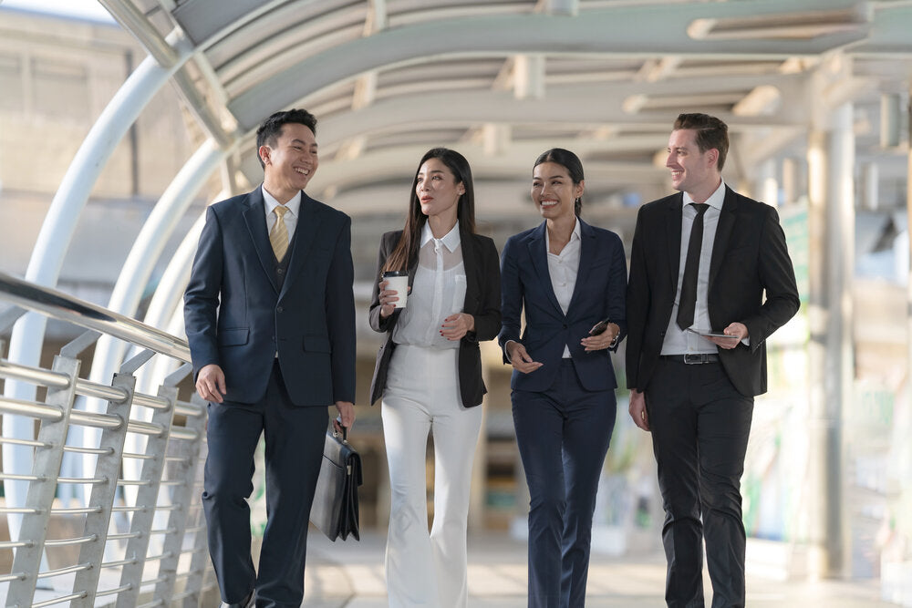 Business professionals walking and discussing plans, illustrating the 9 proven steps to successfully sell your small business