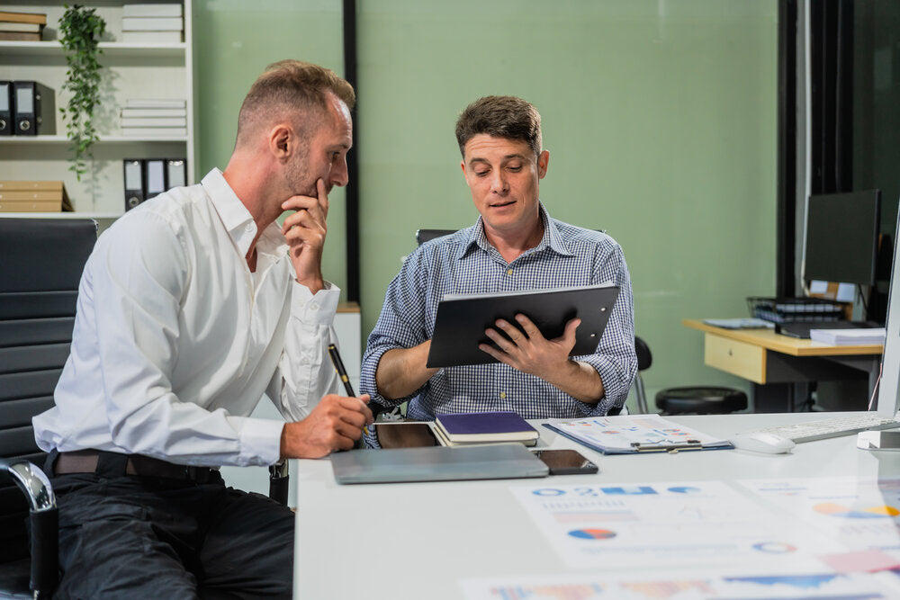 Business sale broker guiding client through full start-to-finish selling process