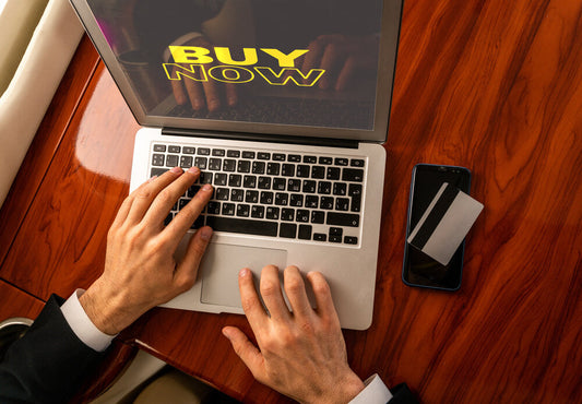 Businessman flying on private jet using laptop to buy or sell a business online