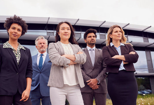 Multi-cultural business team standing outside, symbolizing global collaboration and cross-border business buying opportunities