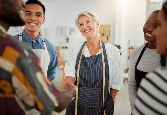 Smiling entrepreneurs from different backgrounds after selling their business