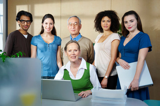 Team of professionals in modern office discussing how to sell a business in the UK and internationally