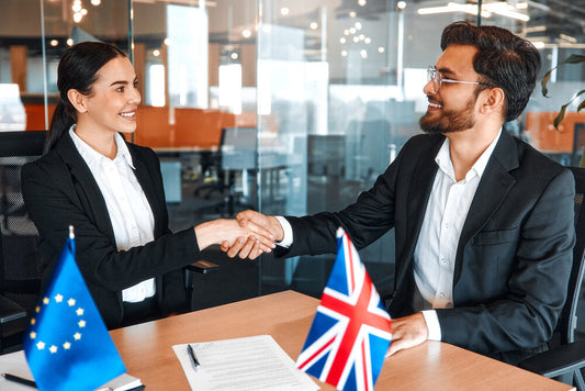Two businesspeople shaking hands after selling a business quickly in the UK