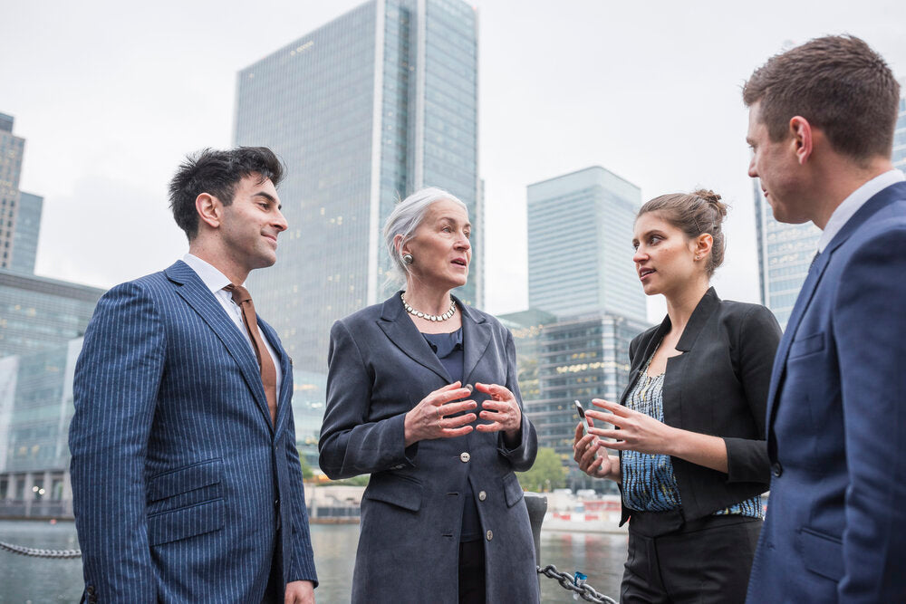 UK business broker and client discussing a business sale outdoors