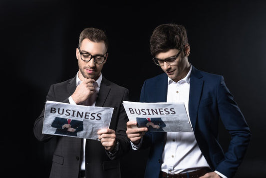 Two confident businessmen standing together in a modern office setting
