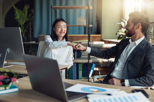 Business owner shaking hands with buyer after successful sale on World Businesses for Sale platform in 2025
