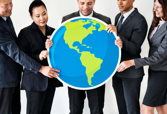 Buyers and sellers holding a world map representing global business opportunities