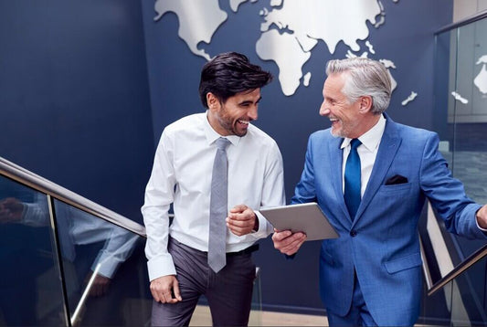 Two businessmen smiling after closing a business deal at World businesses for sale