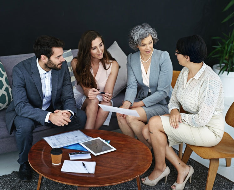 Business professionals meeting to discuss buying and selling businesses on World Businesses for Sale platform.