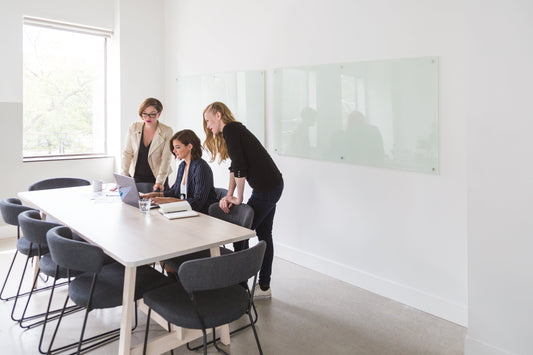 Image showing a business investor reviewing documents and financial data with a consultant, representing the due diligence process in buying a business.