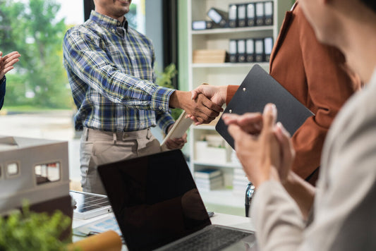 Entrepreneurs shaking hands after buying a business online