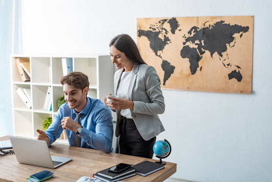 Man and woman researching businesses for sale online on worldbusinessesforsale.com