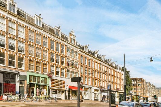 Street view of small businesses for sale in central London, including cafés, shops, and restaurants with people walking by