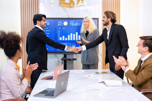 Team discussing business opportunities in a meeting room, brainstorming strategies to buy or sell businesses globally on a trusted online platform.