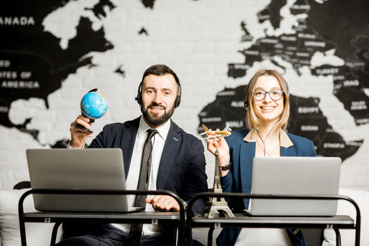 Two travel managers working together in an office, representing collaboration in exploring top global marketplaces to buy or sell a business