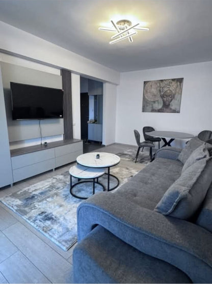 Modern living room with gray sofa, coffee table, and wall art.