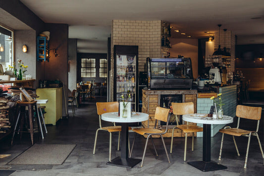 Interior of a cozy Berlin café & bistro with modern décor, seating for guests, and warm lighting.