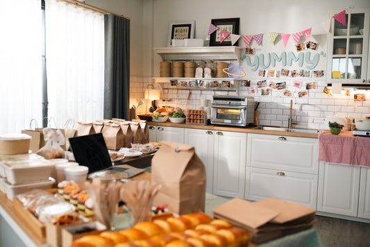 Interior of a Halifax bakery with fresh bread, pastries, cakes on display, and a cozy seating area for customers.